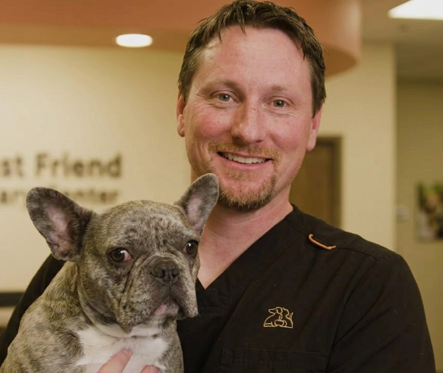 Dr. Tim holding Corndog, the practice’s French bulldog mascot